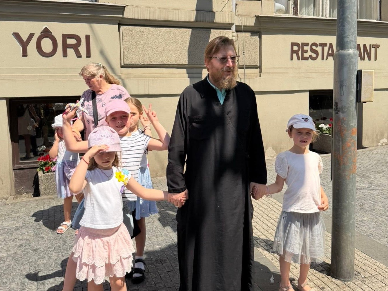 Otec Vasilij s dětmi na procházce Prahou